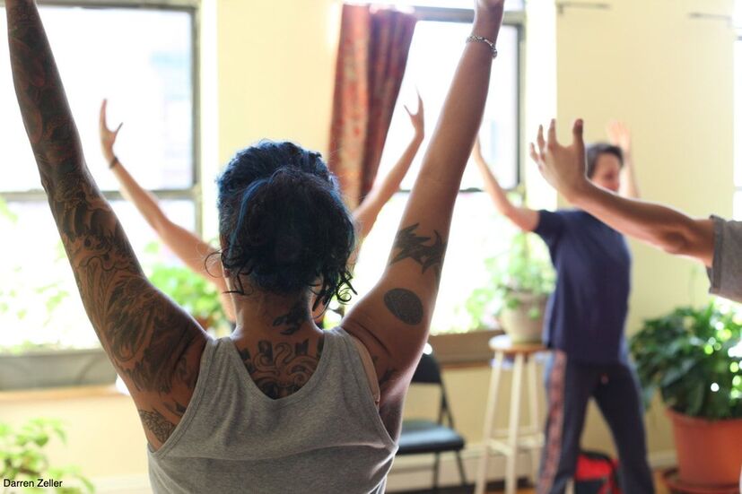 Students-stretch-arms-up-as part of 200-hour-yoga-teacher-training